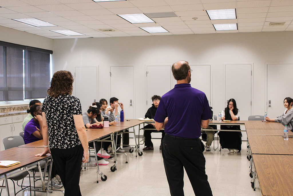 Students at a Conversation Partners meeting listing to instructor.