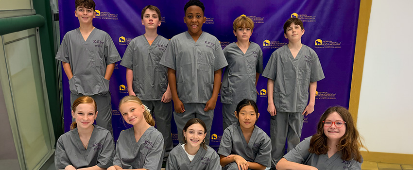 Kilby kids posing in nursing scrubs