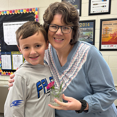 an instructor standing with a child smiling
